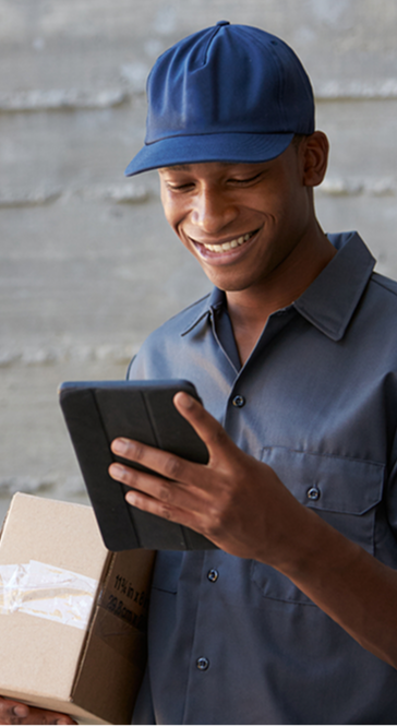 Delivery man smiling while holding packages